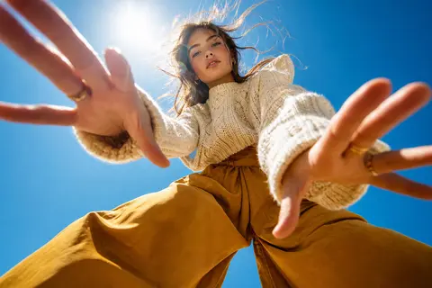 Ground-up fisheye fashion portrait of a young woman towering above the viewer, c - AI生成图片 1
