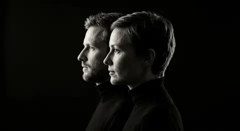 A stark monochrome fine-art portrait of a man and woman posed shoulder-to-should - AI生成图片 1