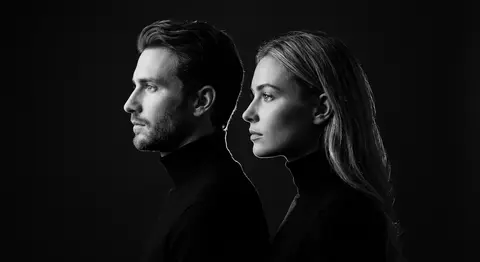 A stark monochrome fine-art portrait of a man and woman posed shoulder-to-should - AI生成图片 2