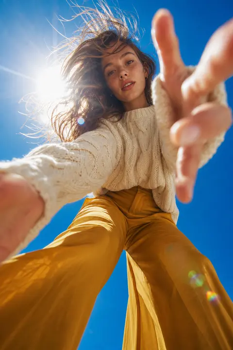Ground-up fisheye fashion portrait of a young woman towering above the viewer, c - AI生成图片 2