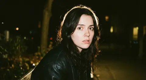 A nostalgic 90s film photography portrait of Elara Voss, preserving the exact fa - AI生成图片 1