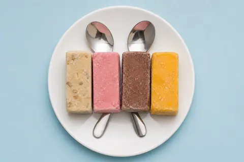 A quartet of rectangular kulfi slices, featuring distinct flavors of cashew-stud - AI生成图片 1