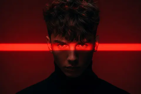 Cinematic studio portrait of a young man with messy textured hair, wearing a bla - AI生成图片 3
